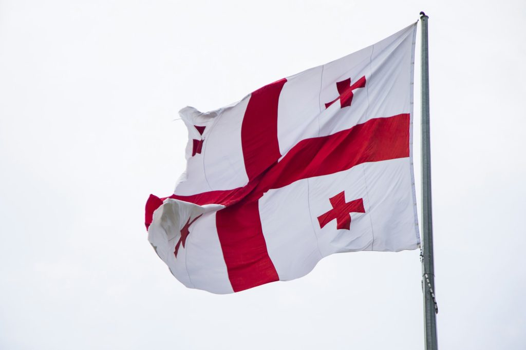 Georgian flag in wind on sky background